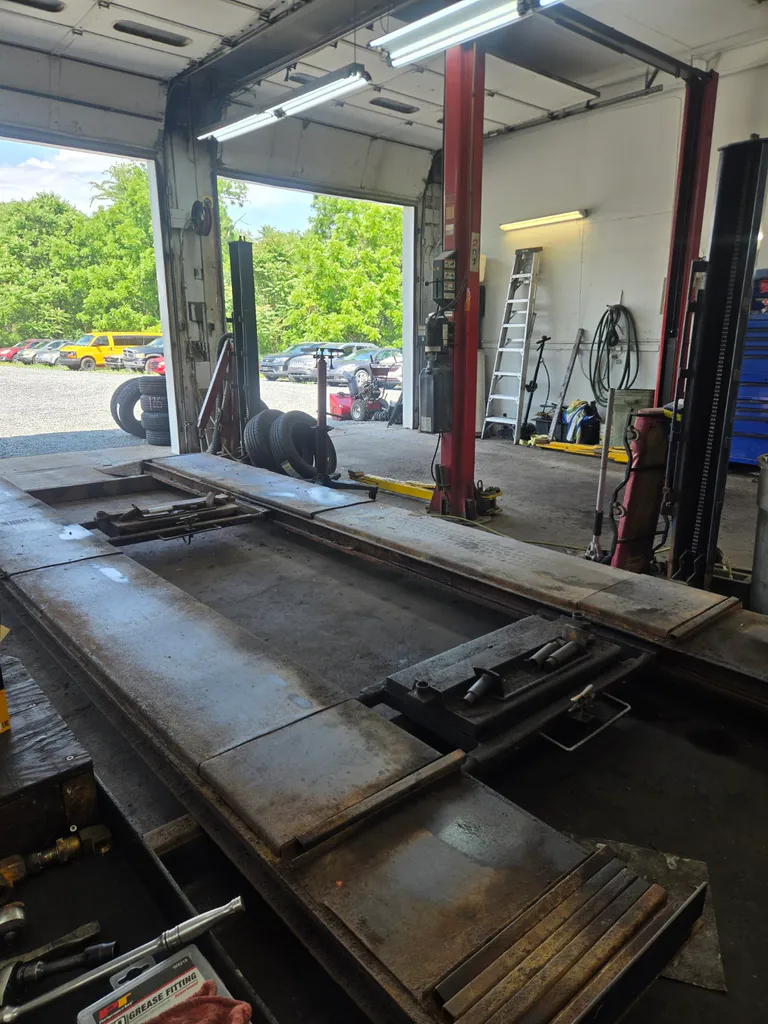 Interior service bays and vehicle lifts at Wrenches Auto Repair
